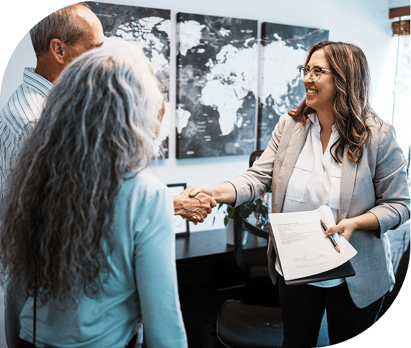 Business meeting handshake with smiling participants.