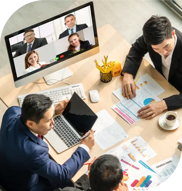Business meeting with video conference and charts.
